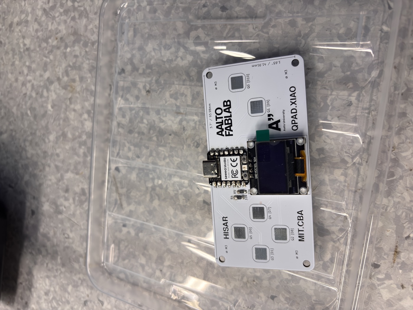 QPAD board after soldering — all components including the OLED screen are soldered onto the board