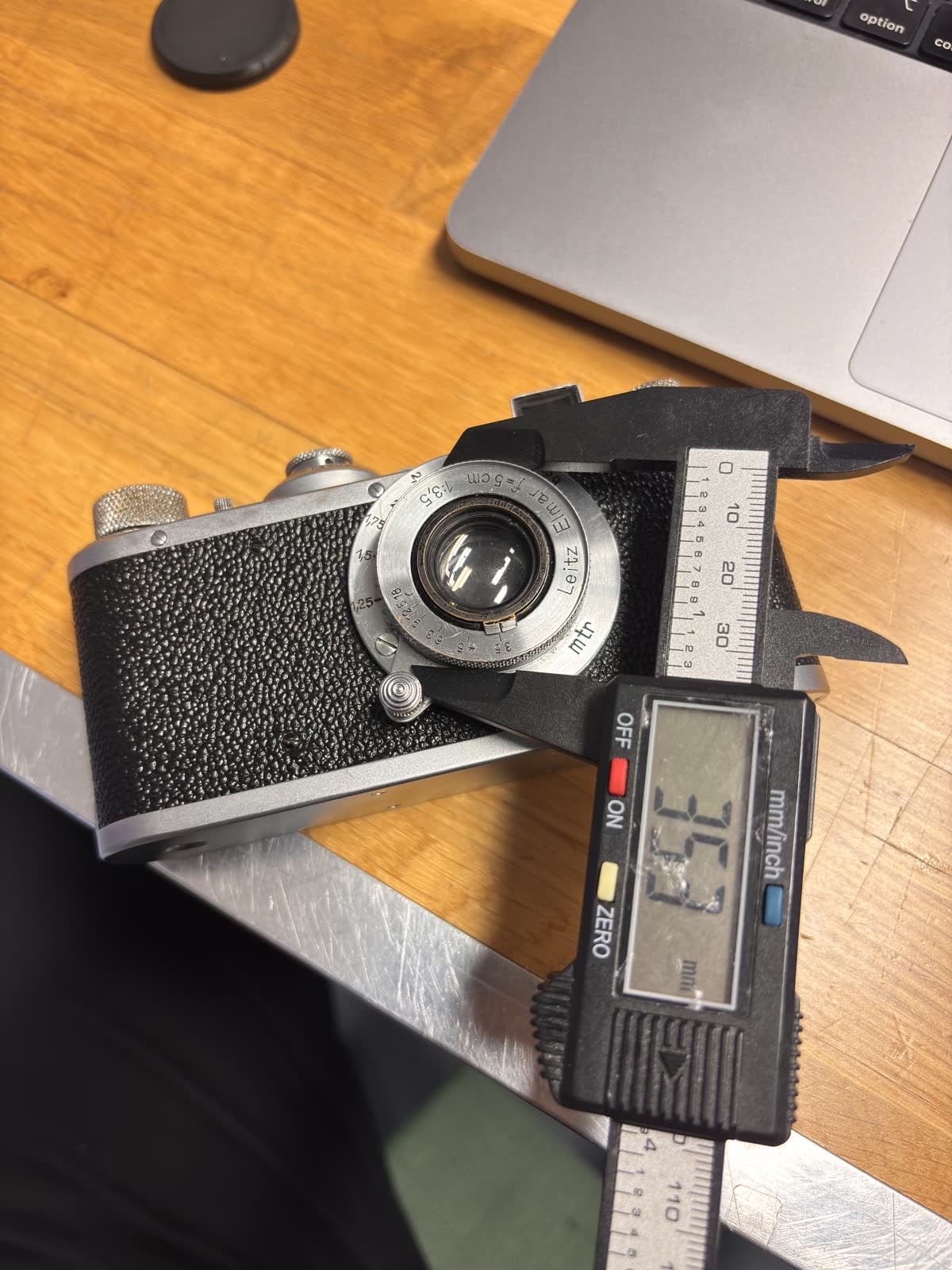 Photo of a film camera with a caliper measuring the outer diameter of the lens barrel to feed into the FreeCAD spreadsheet