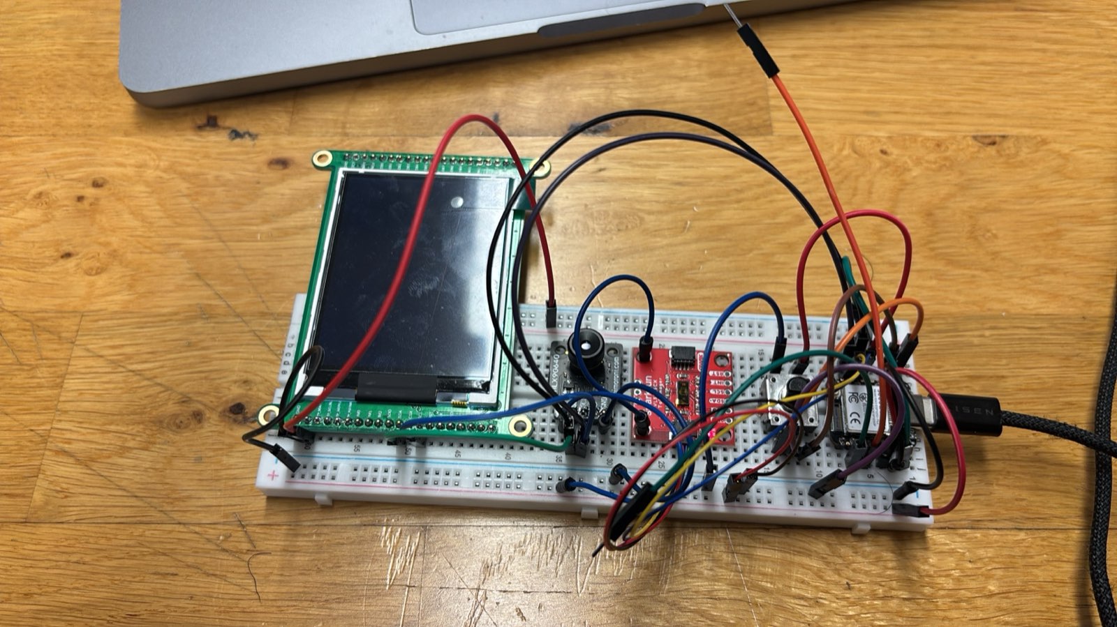 Breadboard prototype of the pedal-version receiver: a XIAO ESP32-S3 and a SparkFun breakout wired to a large TFT display with many jumper wires