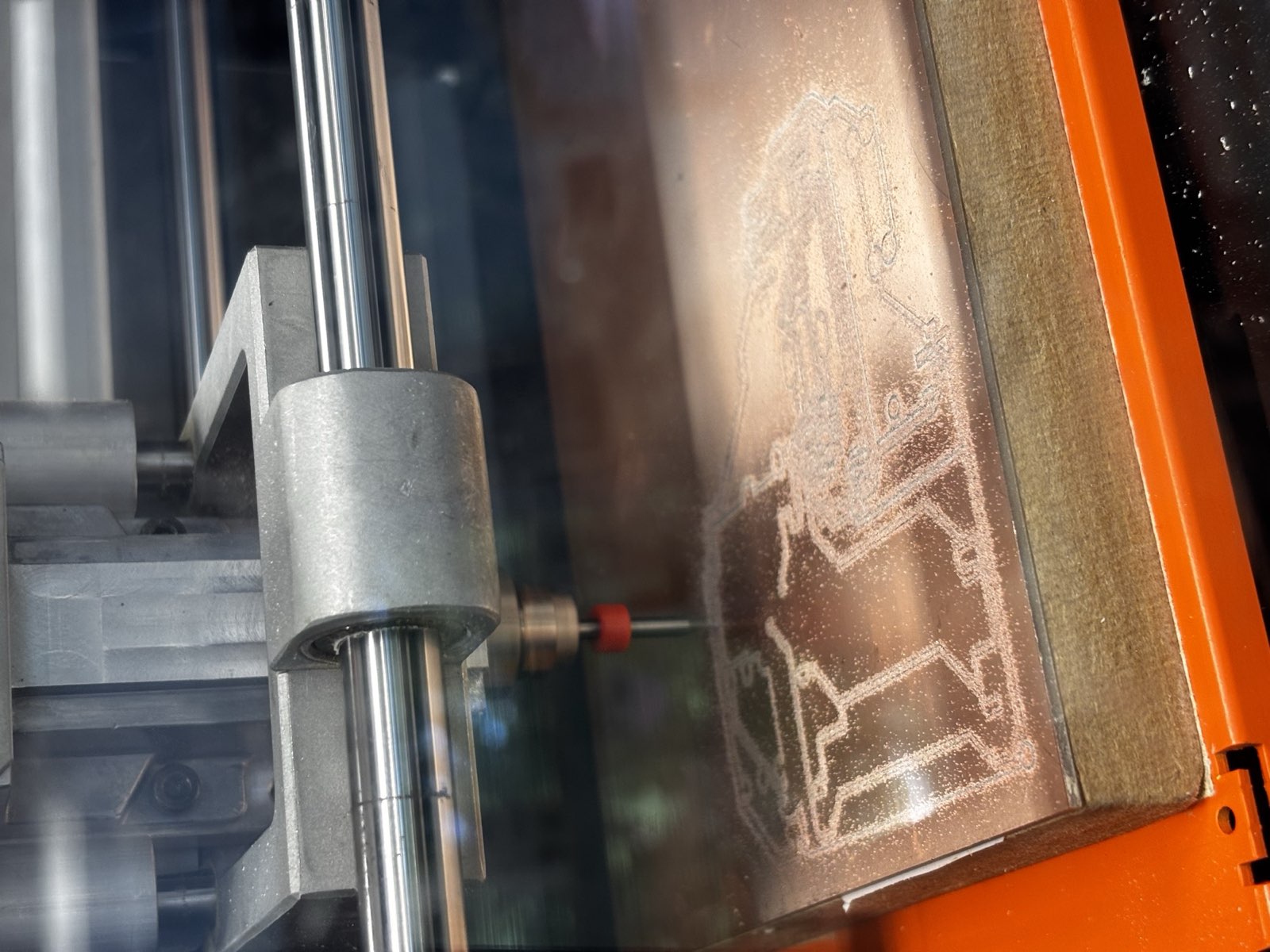 Close-up of the receiver board being milled, the isolation traces showing as light lines in the copper